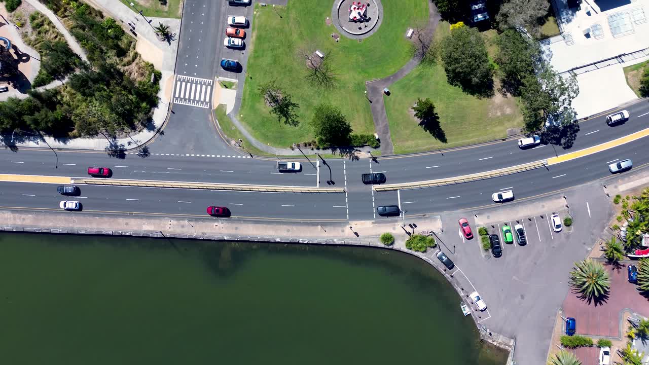 Drone aerial landscape of cars driving on main road with pedestrian crossing at Gosford city waterfront boulevard and carpark on Central Coast Australia travel urban transport and infrastructure