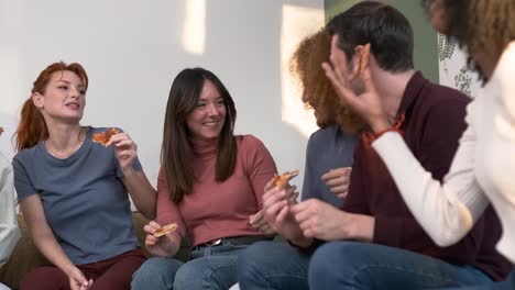 diverse friends cheering up for woman bringing pizzas during weekend party at home