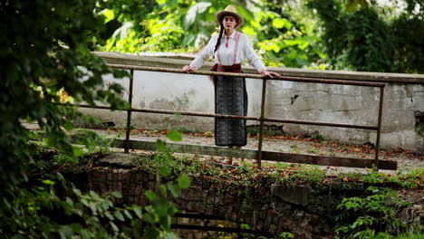 romanian girl admires the stream from the middle of the old bridge 2