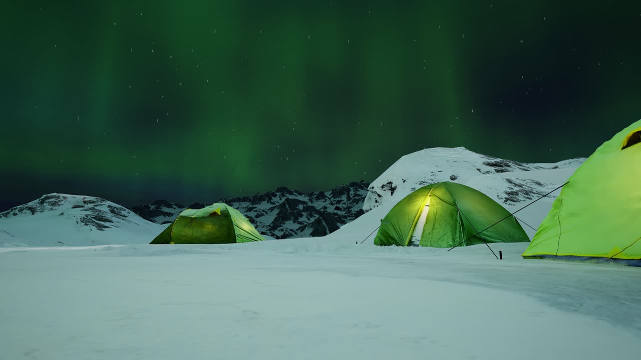 Tent Lighted From The Inside Against The Backdrop Of Incredible Sky With Northern Lights. Aurora Borealis In Winter Field