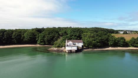 abandoned welsh coastal property aerial view establishing idyllic turquoise holyhead beach woodland