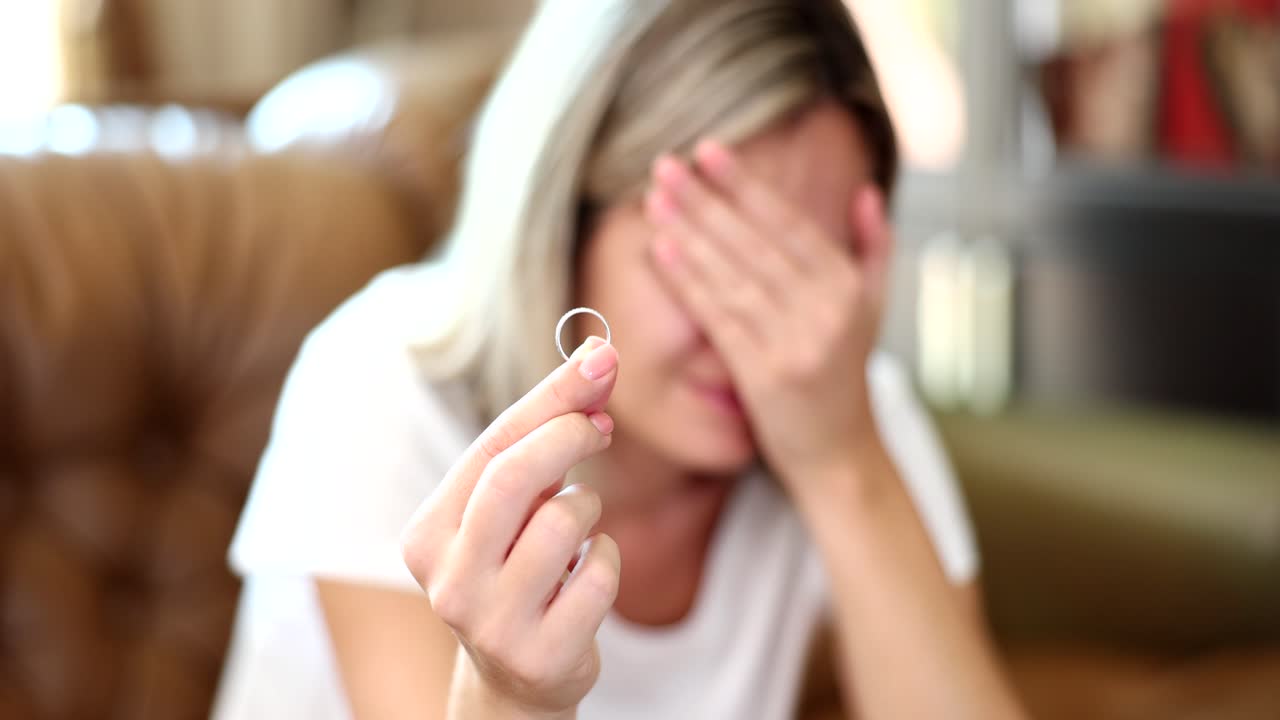 Sad woman holding a ring
