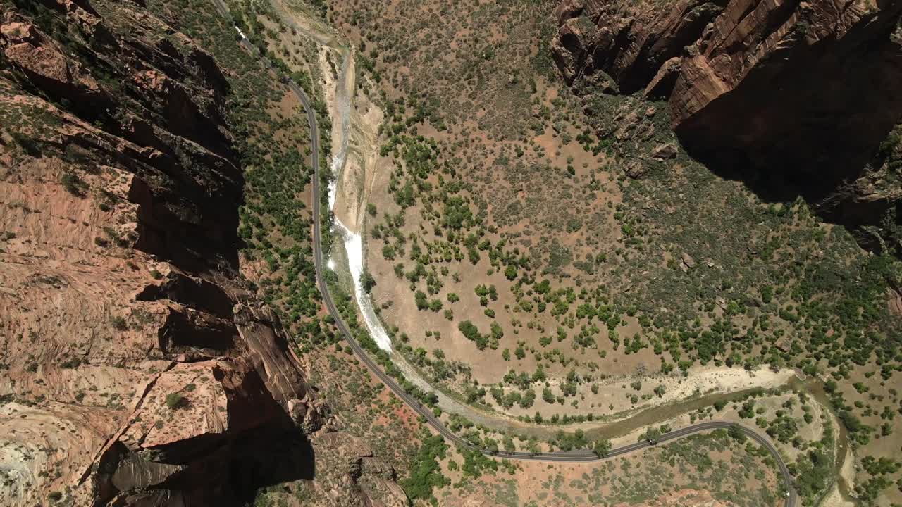 Aerial drone footage offering a bird's-eye view of Zion National Park, highlighting the rock formations and the remnants of water flow