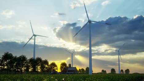 wind turbines standing in sunset. farm with wind turbines. generating clean renewable energy. bright orange sunset. alternative energy