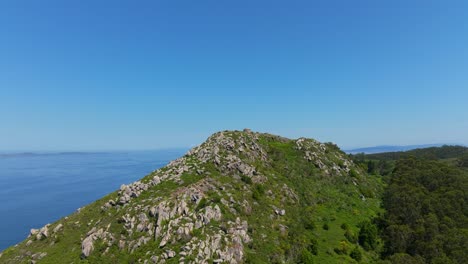 rocky slope and peak of mountain overlooking the north atlantic ocean in summer