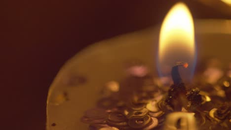 the warm golden flame of a candle - static macro shot in amazing detail