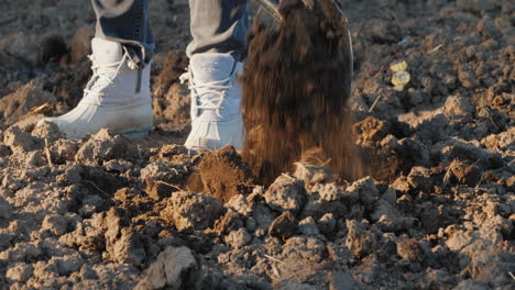 farmer's legs with a shovel digs a vegetable garden manual rural labor