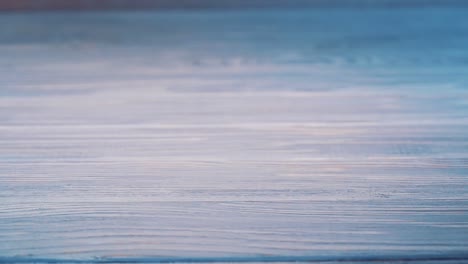 modern white touchscreen phone is falling on the floor and crashes isolated on the wooden background floor. broken smartphone on the grey surface.