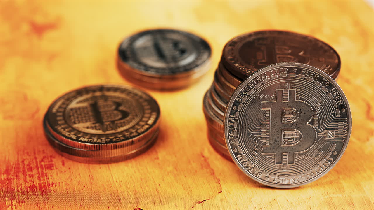 Close up of shiny physical Bitcoin coins stacked on a table