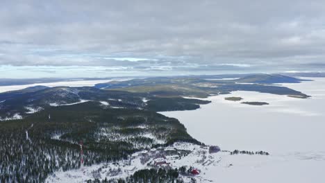 Drone-Flight-Above-Hills-And-Islands-Among-Frozen-Lakes-In-Finland-In-Winter