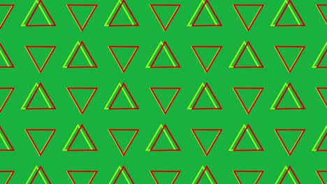 triángulos giratorios en formación sobre un fondo verde