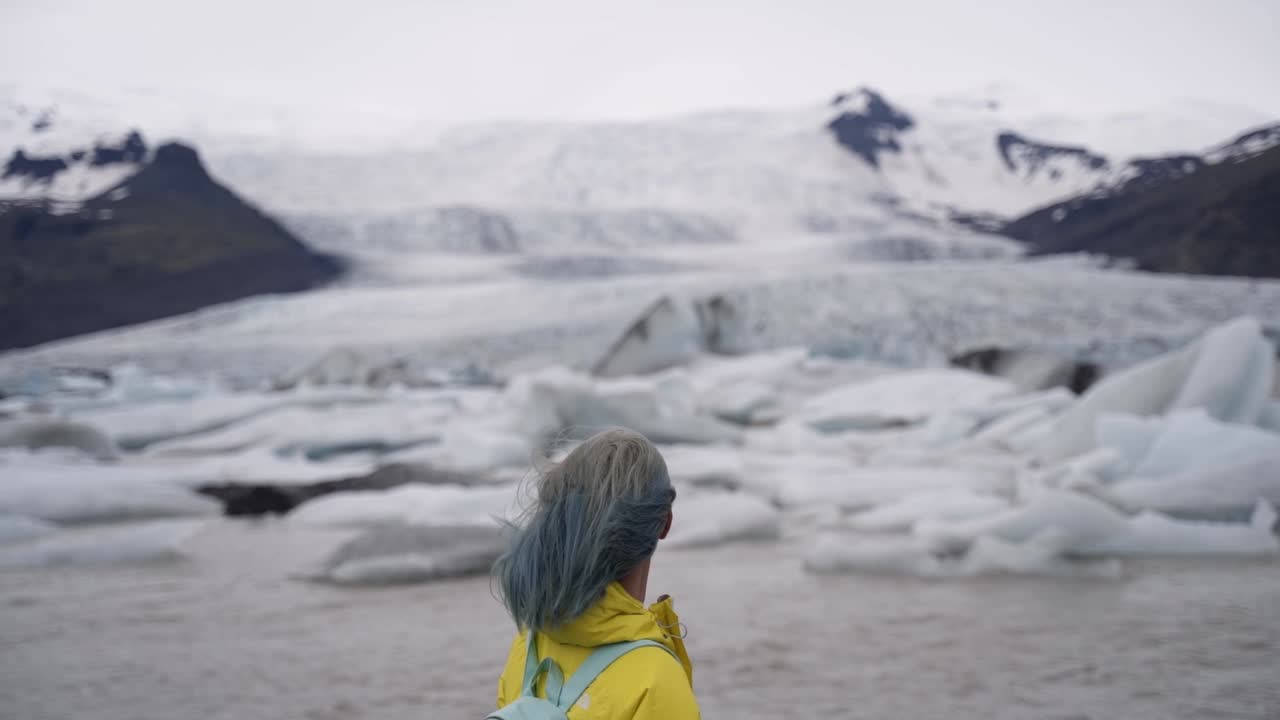 This is a lady enjoying her view of nearby glaciers in Iceland.