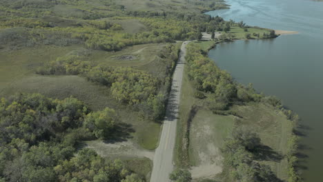 Car-Driving-In-The-Road-At-Buffalo-Pound-Lake-And-Provincial-Park-In-Saskatchewan,-Canada