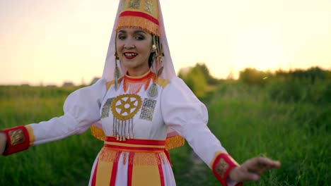 close-up. dance of young woman in traditional costume of mari people