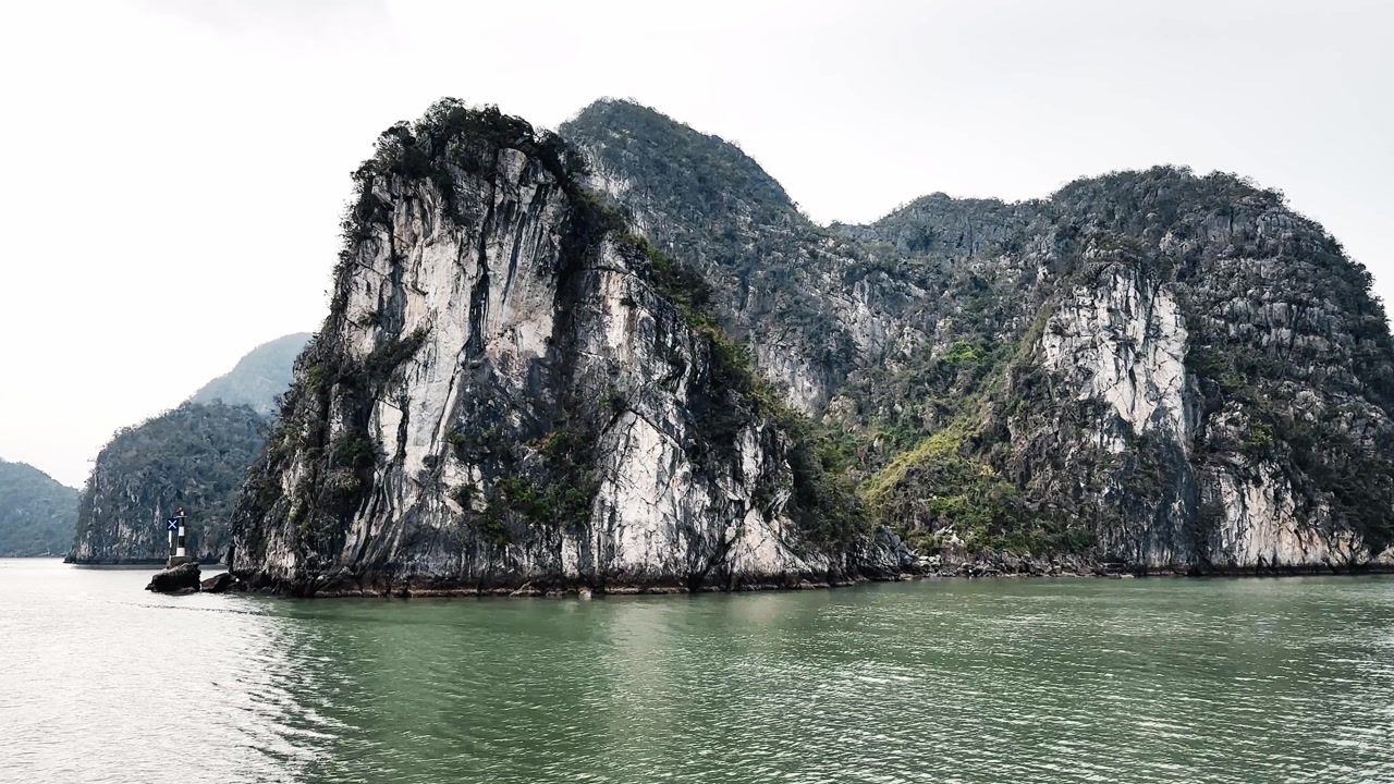 A beautiful shot of the limestone hills in Halong Bay, Vietnam, surrounded by calm waters