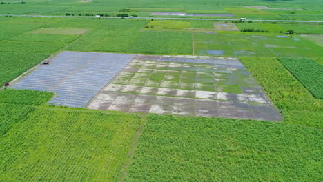 Toma-De-órbita-Aérea-Amplia-De-Una-Nueva-Granja-En-El-Centro-De-Un-Paisaje