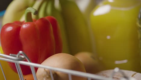 Close-Up-Shot-Of-Person-Taking-Basic-Food-Items-From-Supermarket-Shopping-Basket