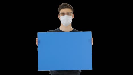 young man in medical mask showing and displaying placard,