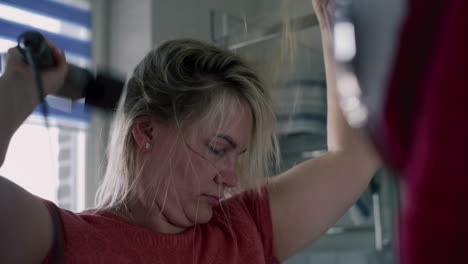 woman drying her hair in the bathroom