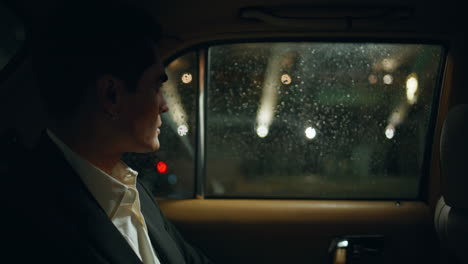 elegant man using telephone night automobile closeup. serious ceo looking window
