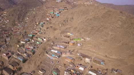 sprawling hillside settlements with colorful homes in a dry, rugged landscape. perfect for editorial, urban development, and environmental impact projects