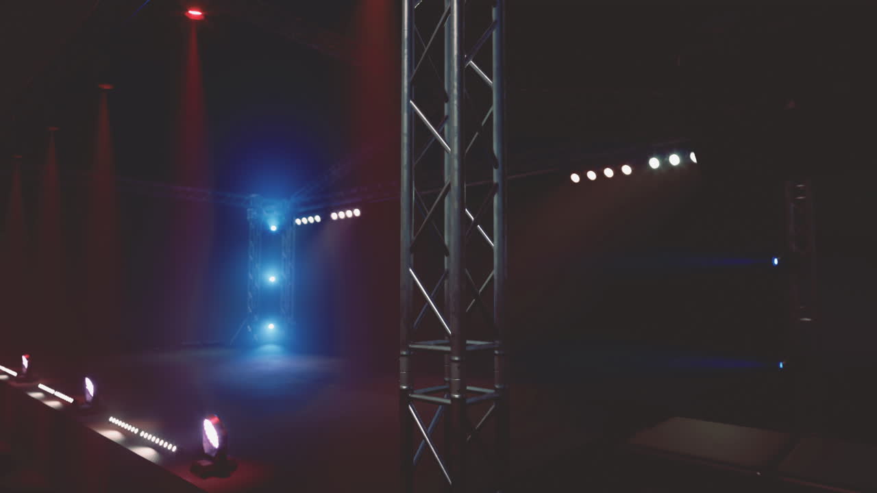 Light effects and stage setup create an energetic atmosphere for an event