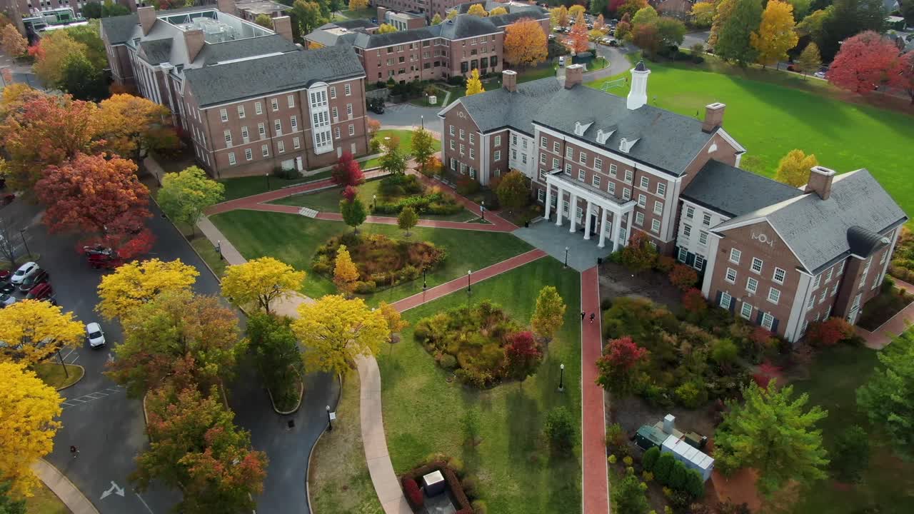 Aerial of beautiful college campus Federal style brick academic buildings during autumn