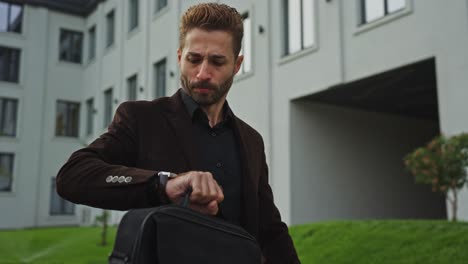 businessman in front of an apartment building
