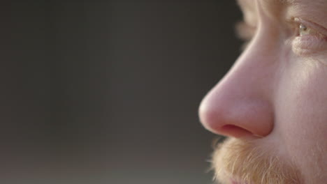 ecu of a handsome bearded ice bather doing conscious breathing before taking the plunge