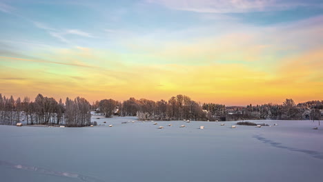 Time-lapse-flowing-clouds-over-in-winter,-Snow-covered-tree-foreground