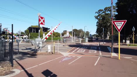 Barrier closing to stop vehicles, train is due