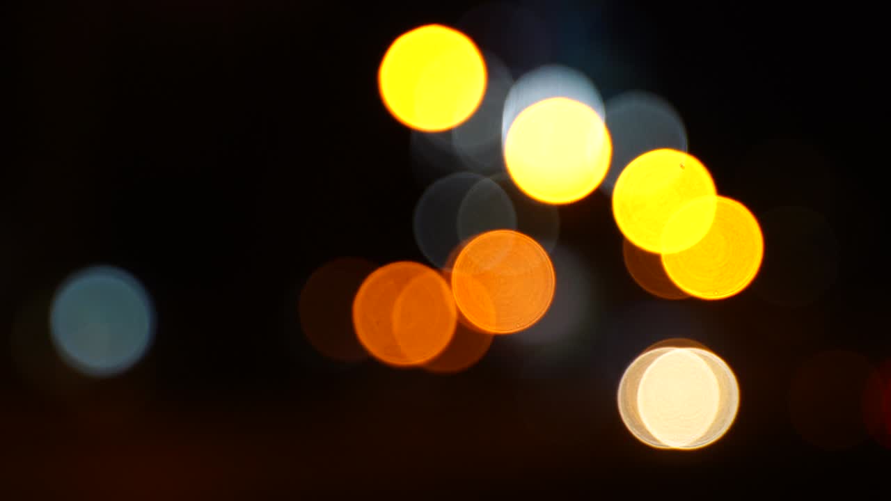 Blurred bokeh traffic on the road at night in a big city.