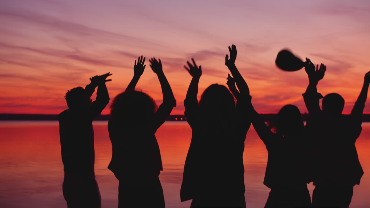 Friends Dancing at Sunset by the Lake