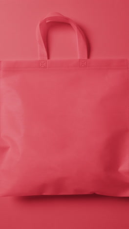 vertical video of red canvas bag with copy space on red background