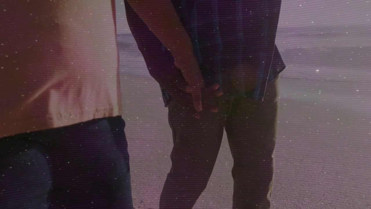 Romance woman walking shore dusk, man reaching, linking fingers, seeking comfort, flares appearing