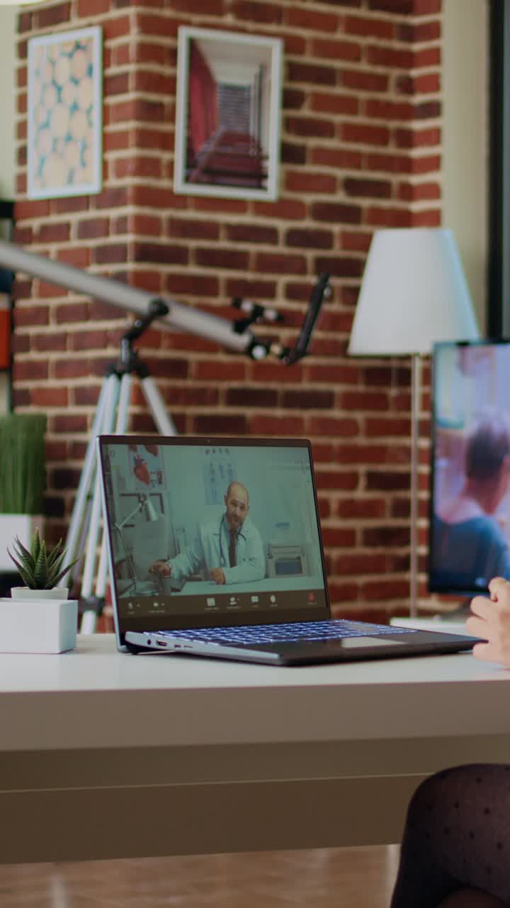 Vertical video Remotely working employee in telemedicine video call asking for medical advice