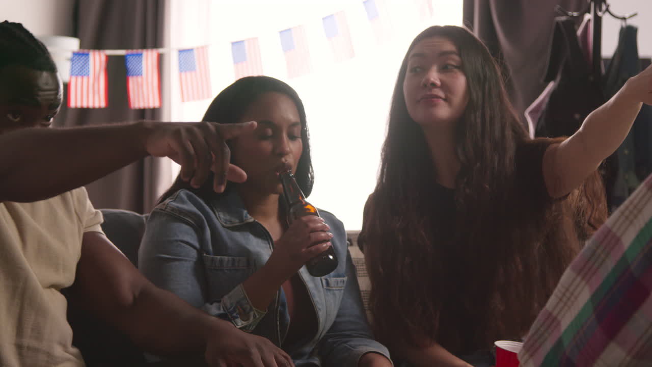 Friends At Home Celebrating With Party For American Independence Day 4th July Talking And Drinking 4