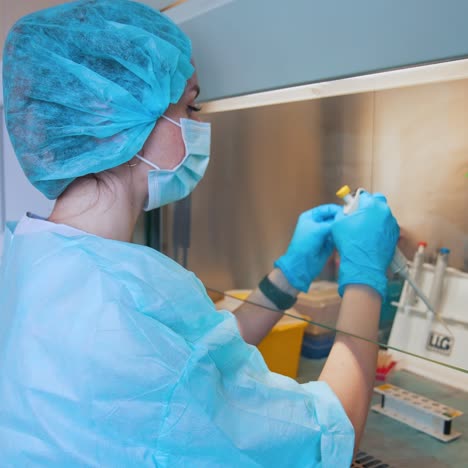 doctor with test tube at laboratory. doctor hand taking sample tube from rack
