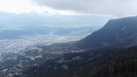 Innsbruck-Airport-and-Valley-Landscape-Surroundings,-High-Aerial-View