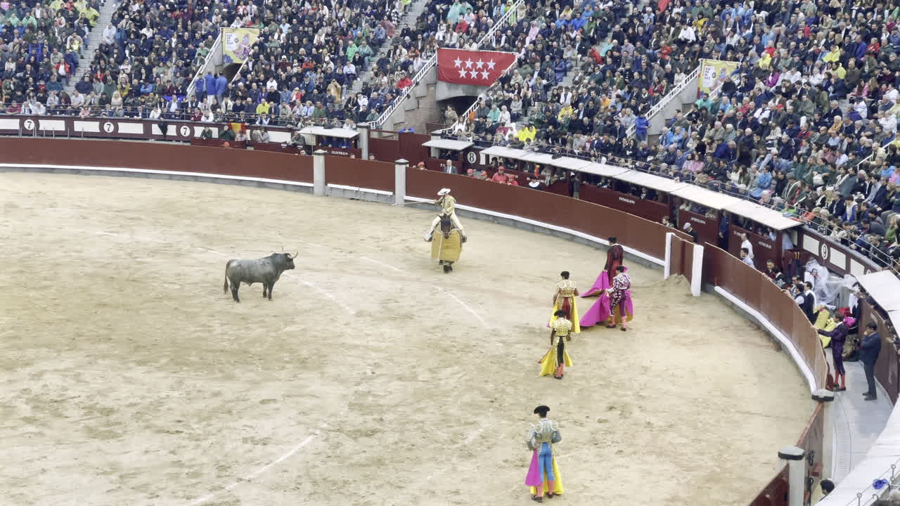 Bullring spectacle at Las Ventas, Madrid, with packed seats and bullfighters in the ring