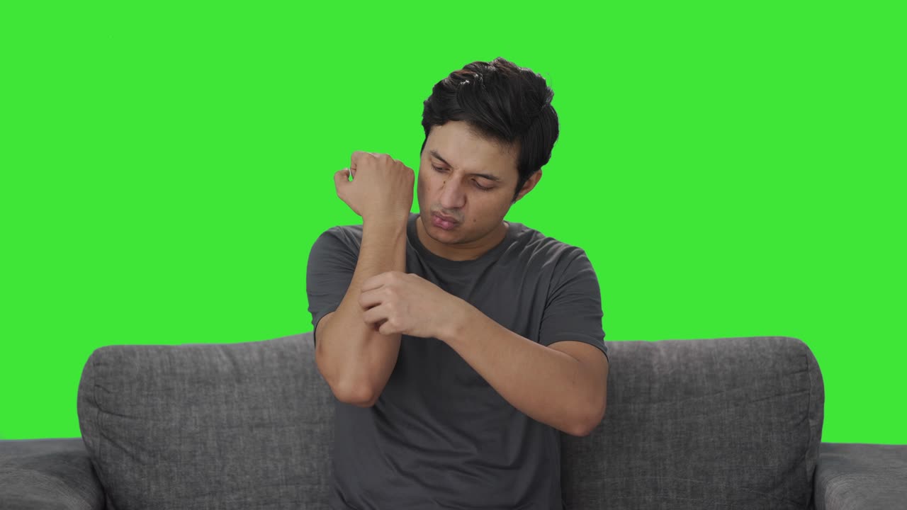 Indian man removing the bandage from hand Green screen