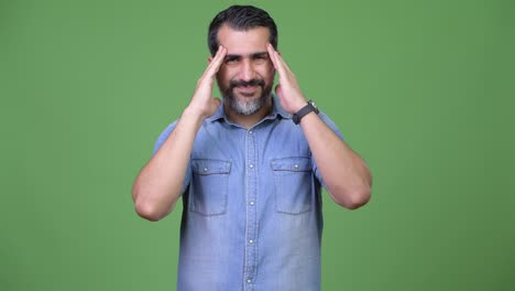 handsome persian bearded man having headache