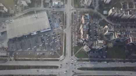 flying over a concrete living apartment area in east europa with many birds flying around the drone