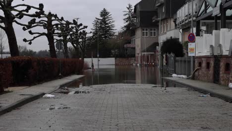 kid walks in the flooded walkway in the town of walluf in germany