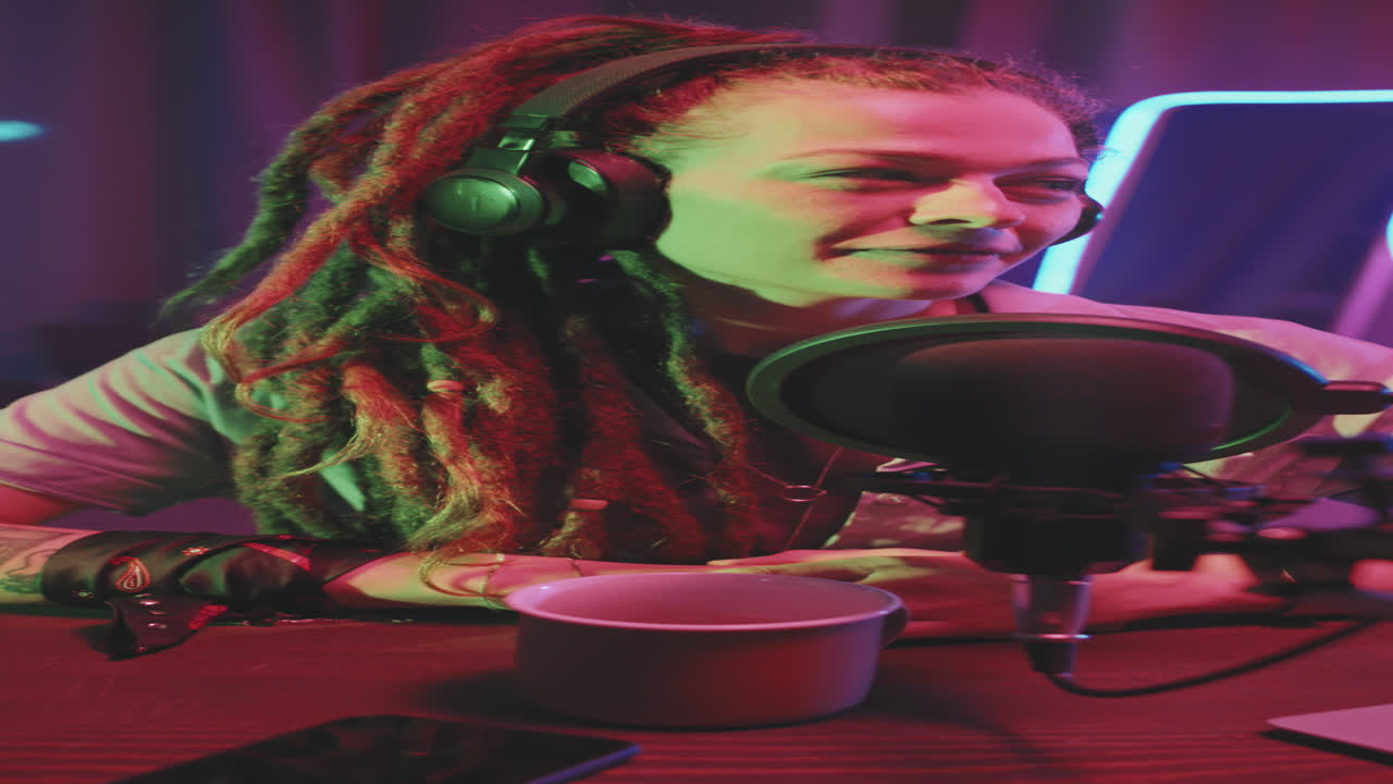 Vertical Shot of Woman with Dreadlocks on Podcast