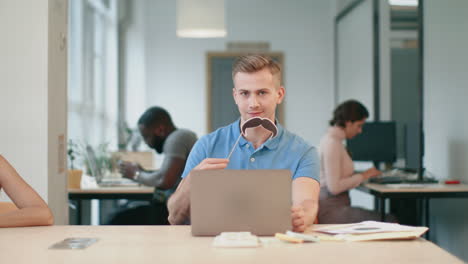 business man working on computer at coworking. cheerful professional making male