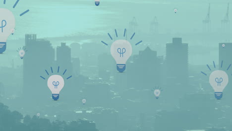 animación de múltiples iconos de bombillas eléctricas flotando contra la vista aérea del paisaje urbano.
