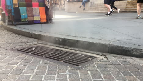 Steam-rising-from-New-York-city-street-grate-and-People-walking-by