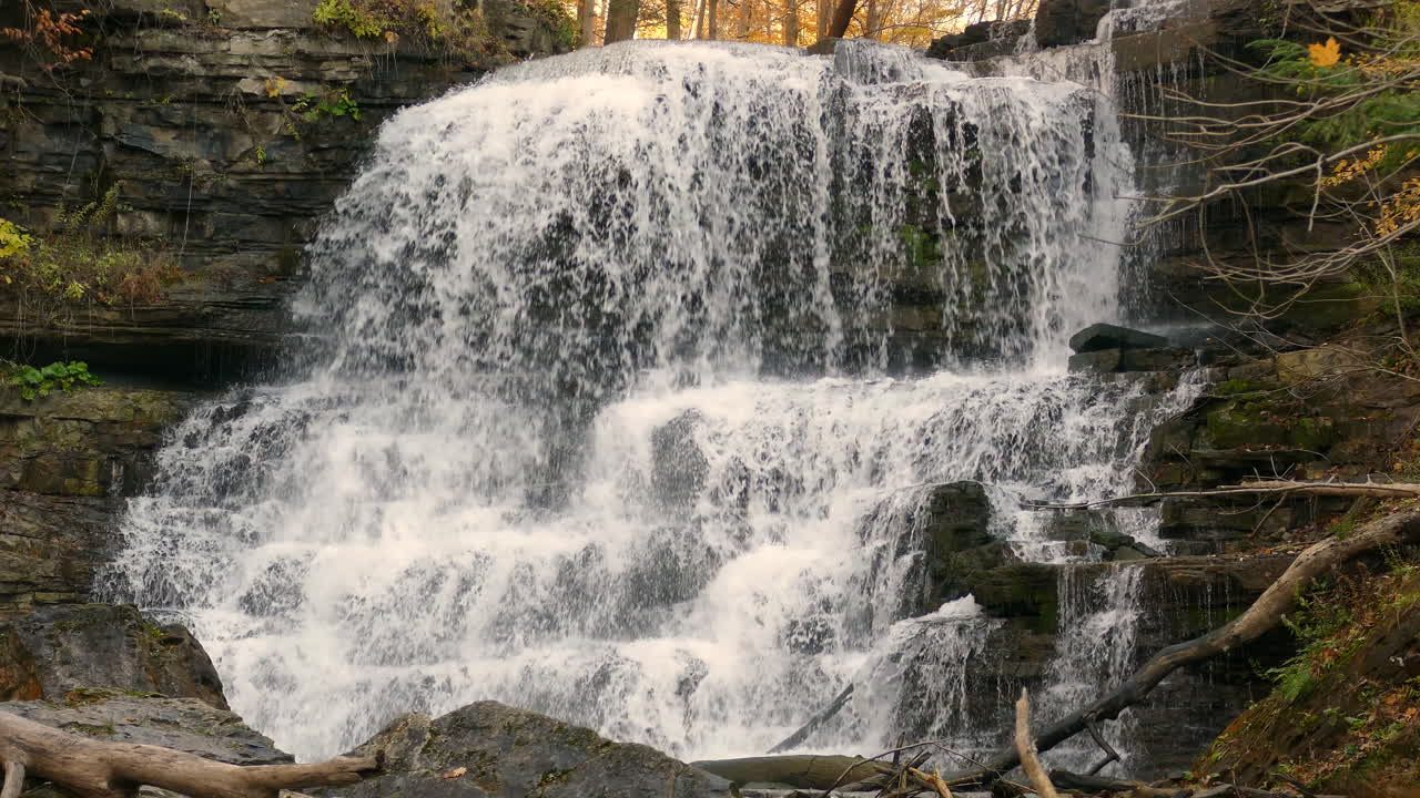 View of the river waterfall in the forest, water falls down the rocks, static