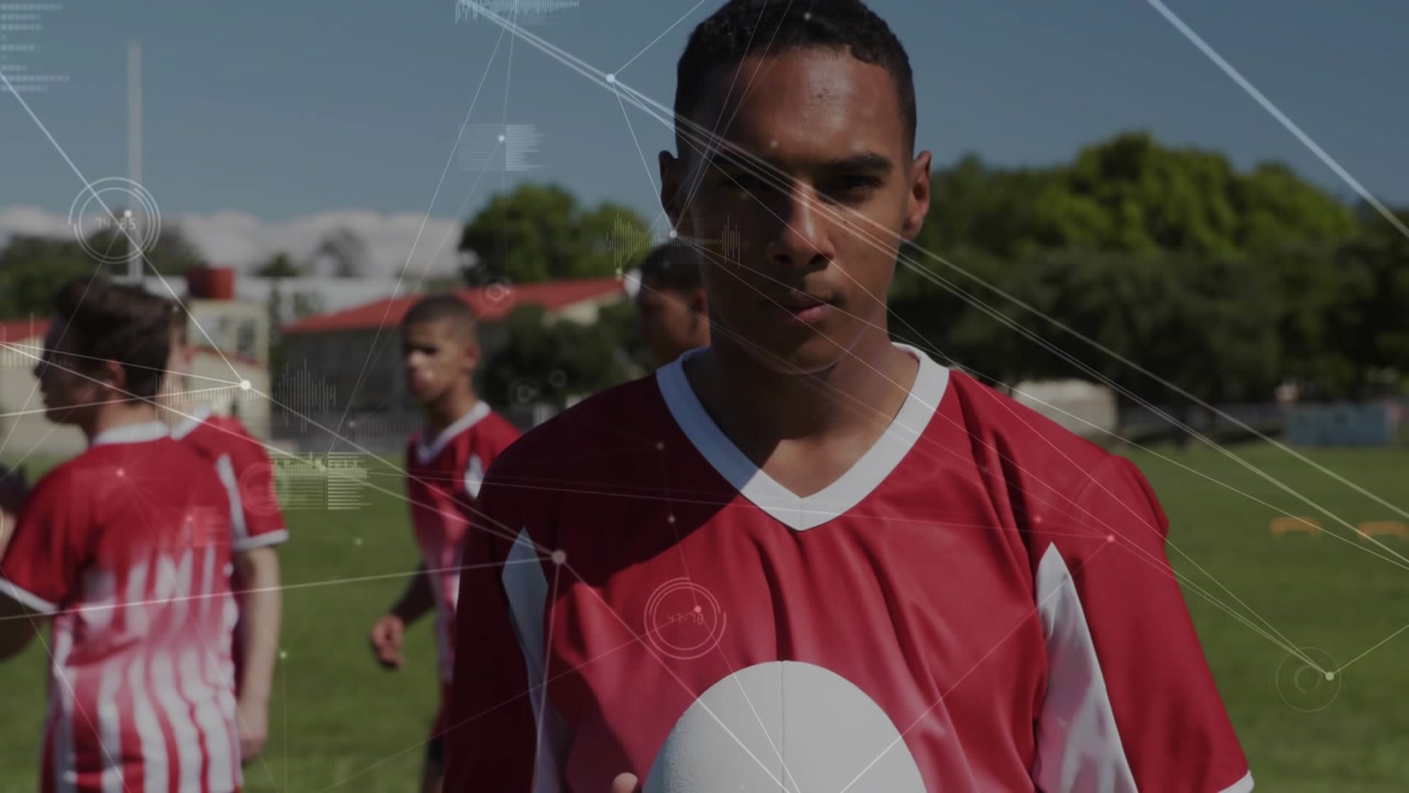 Teenage athlete stepping onto sports field and inspecting ball, activating sports analytics overlay